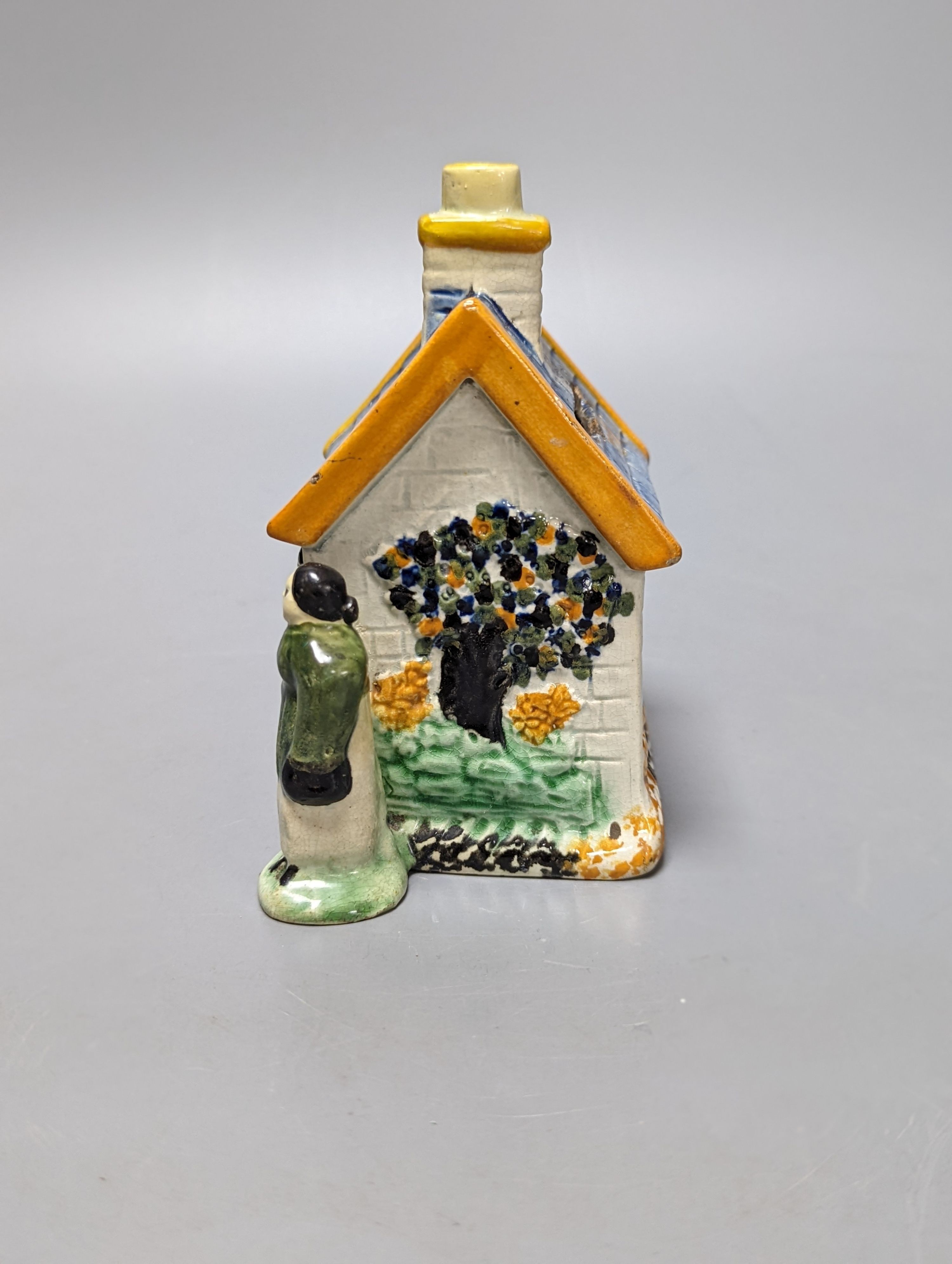 A Staffordshire Prattware money box, c.1810, and another later example (2) both 12.5cm, faults